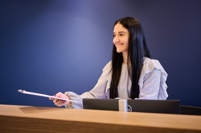 A lady with a report on her hand
